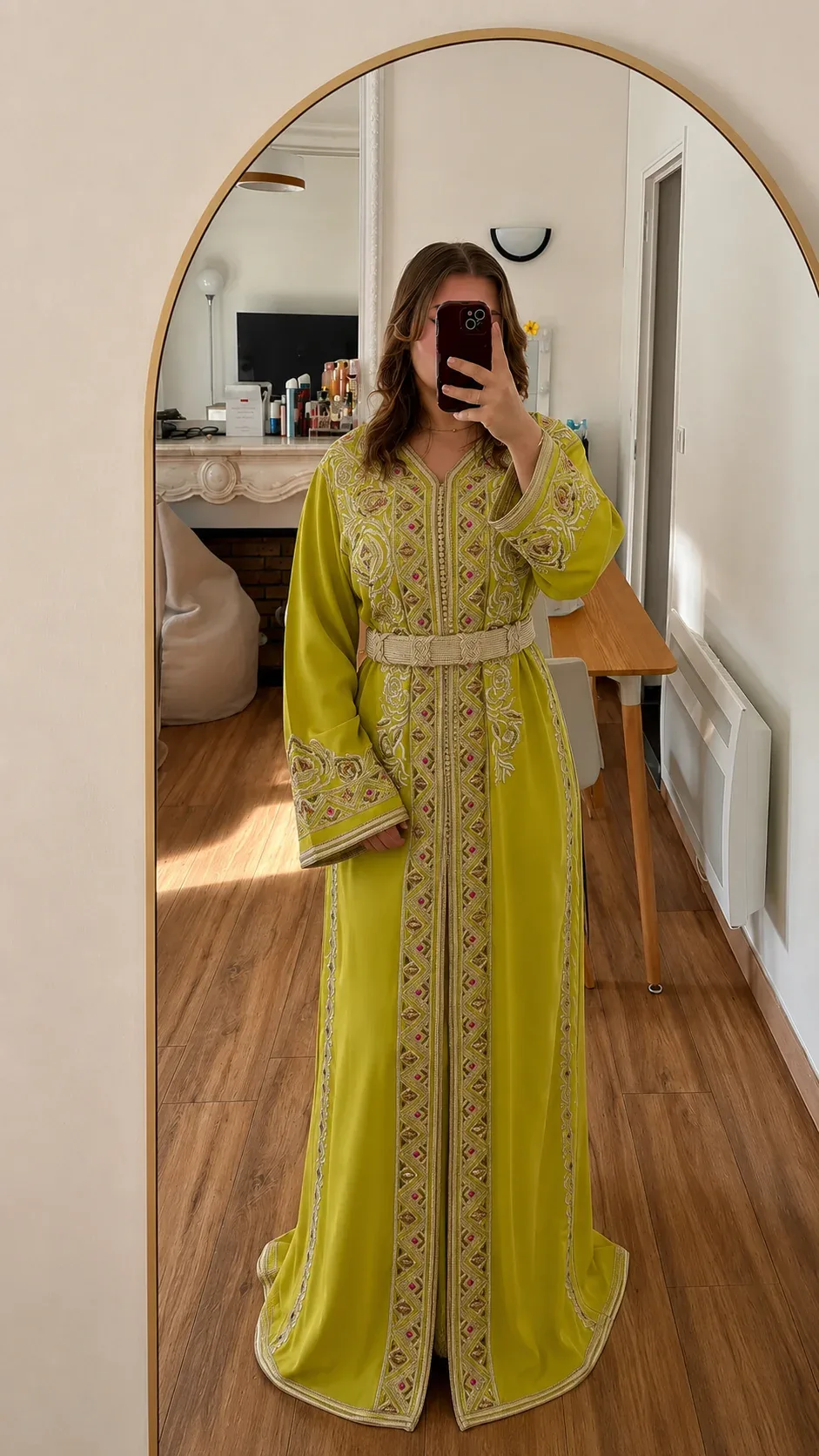 Citron-gold Moroccan takchita worn belted, boutique mirror view