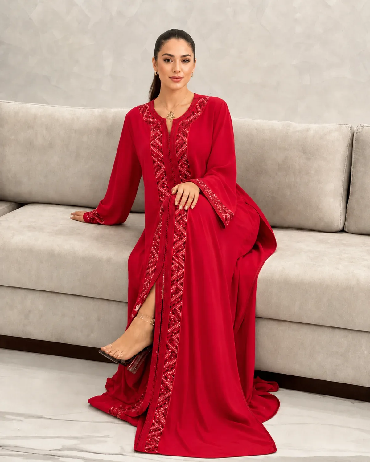 Raspberry red Moroccan caftan worn while seated at a celebration